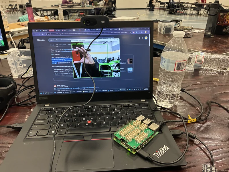 Photo of a laptop and webcam running the GuideSense vision preview, with me photographing myself in the camera feed.